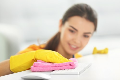 Technician using upholstery cleaning equipment on a sofa
